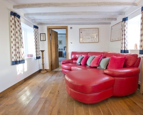 small living room with red leather sofa